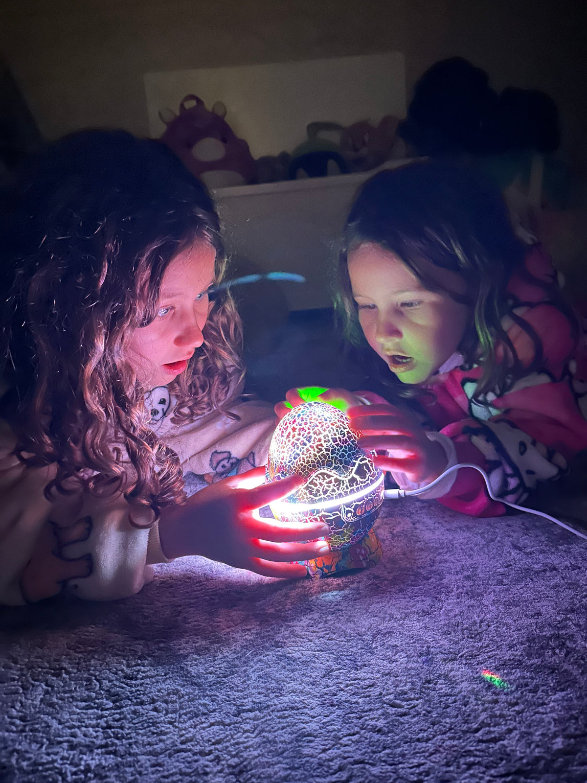 Two girls admiring their nightlight glowing