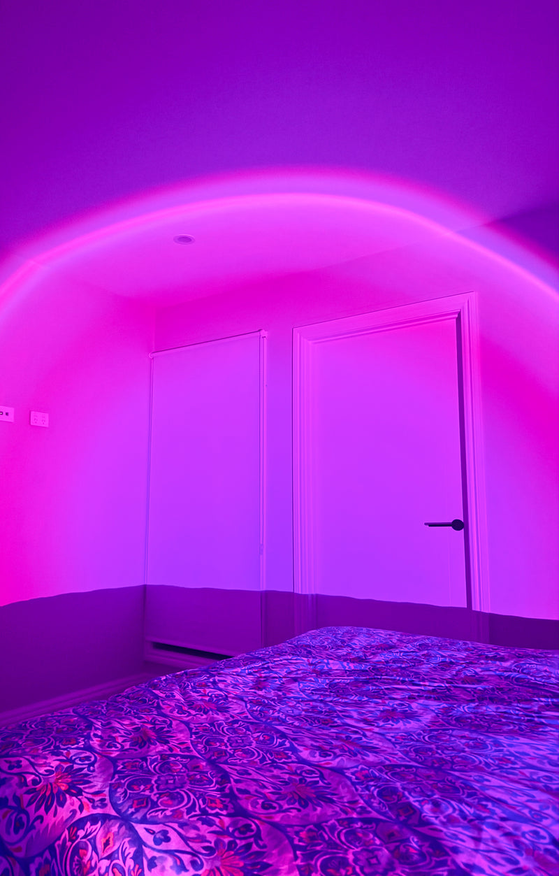 Sunset lamp glowing a soft pink light in the cosy quiet bedroom